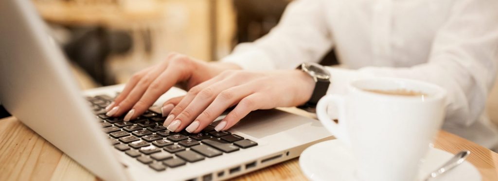 Woman working on Laptop at a cafe - small