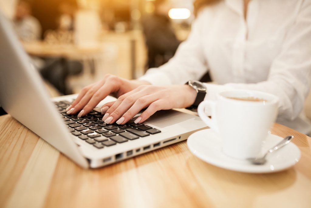 Woman working on Laptop at a cafe